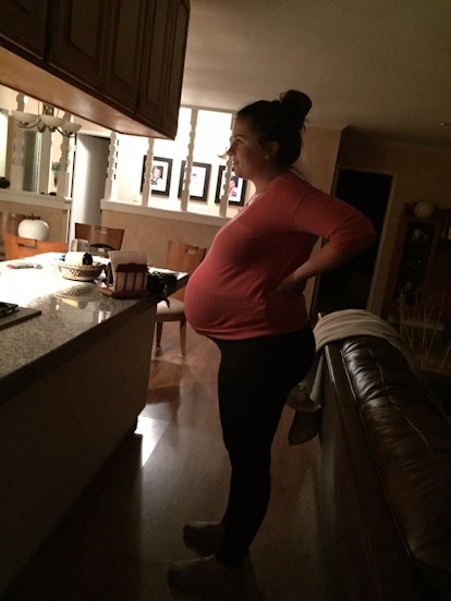 Haley DePass standing up, trying to induce labor