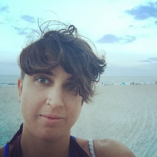 A birth mother posing on a cloudy day at the beach