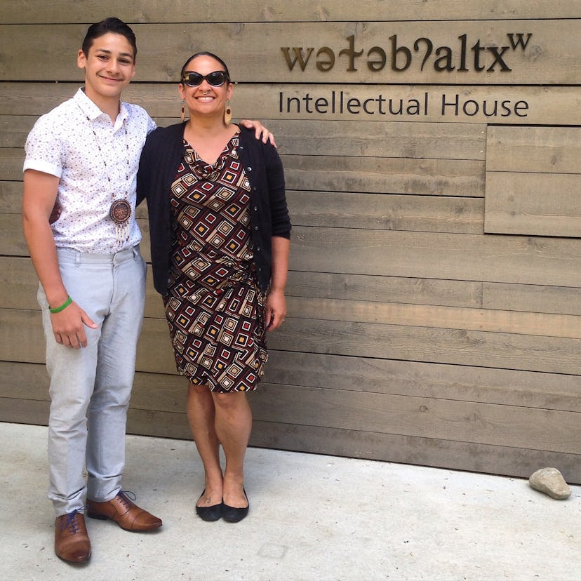 Two people standing in front of Intellectual House, smiling and posing for a picture