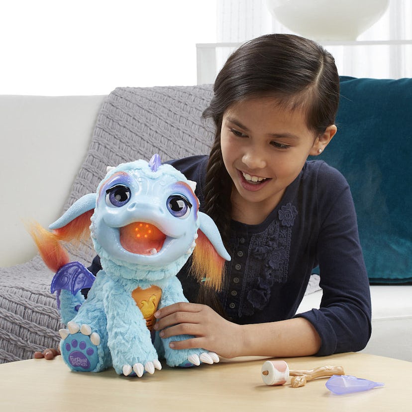 A girl playing with her blue blazin' dragon