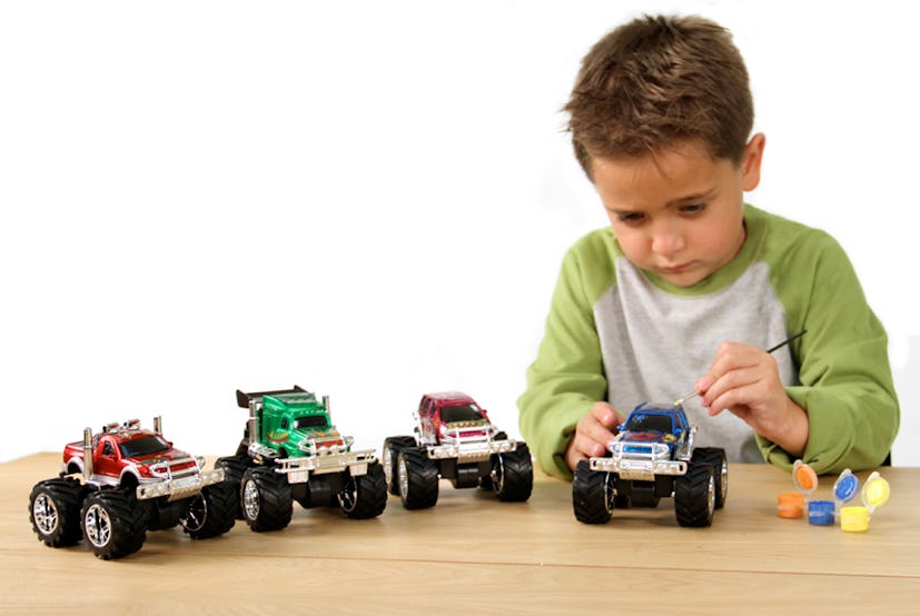 Boy playing with his monster trucks