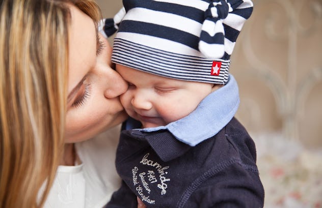 A mother kissing her baby son