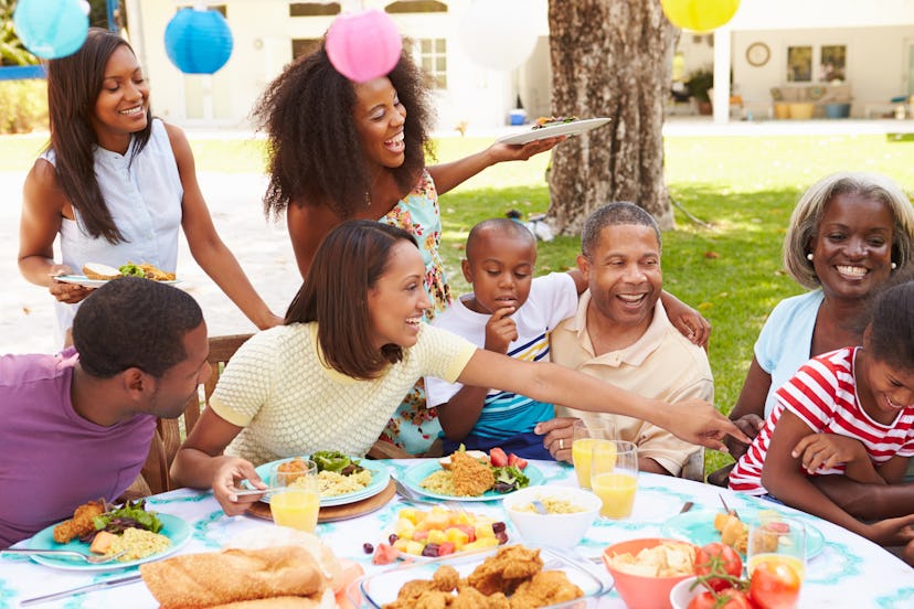 Family sitting at the table, eating and celebrating 