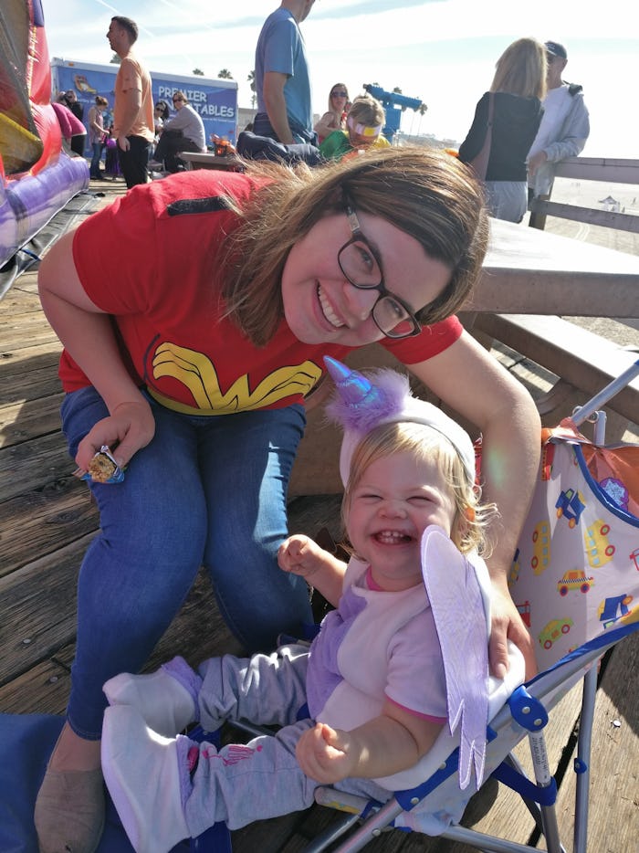 A mother posing for a photo with her baby child