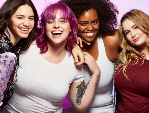 Four women smiling at the camera, looking excited and optimistic. 