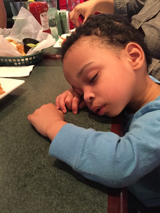 A toddler sleeping on the table