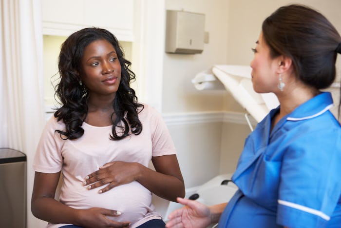A woman with a high-risk pregnancy at the doctor's office getting a checkup
