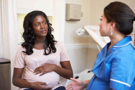 A woman with a high-risk pregnancy at the doctor's office getting a checkup