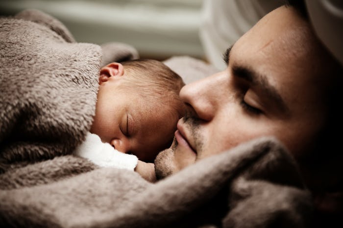 A father sleeping with his baby during family leave