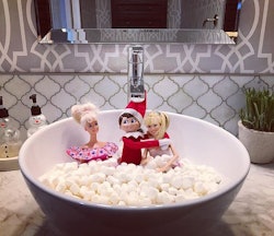 elf on the shelf in mini marshmallow bath with two barbies as an NSFW elf on the shelf idea for adul...