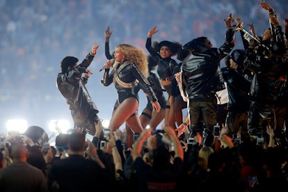 Beyonce performing the song at her concert with a group of people on stage