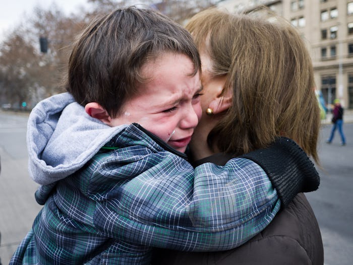 A child and mom hugging as the child cries after a fight with the mom