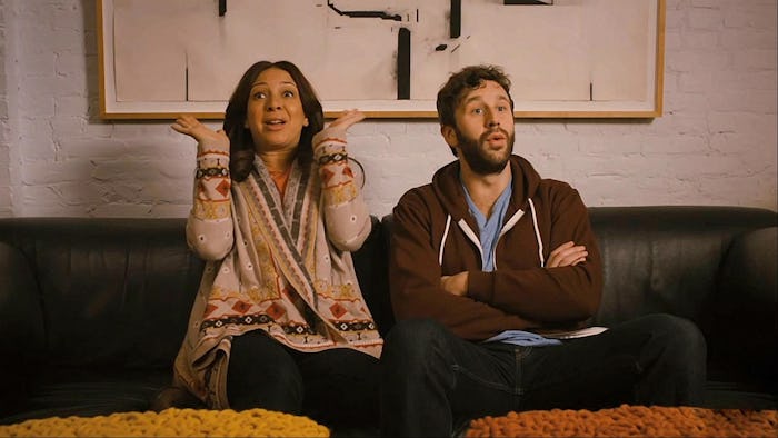 Two people without kids sitting on a couch and talking