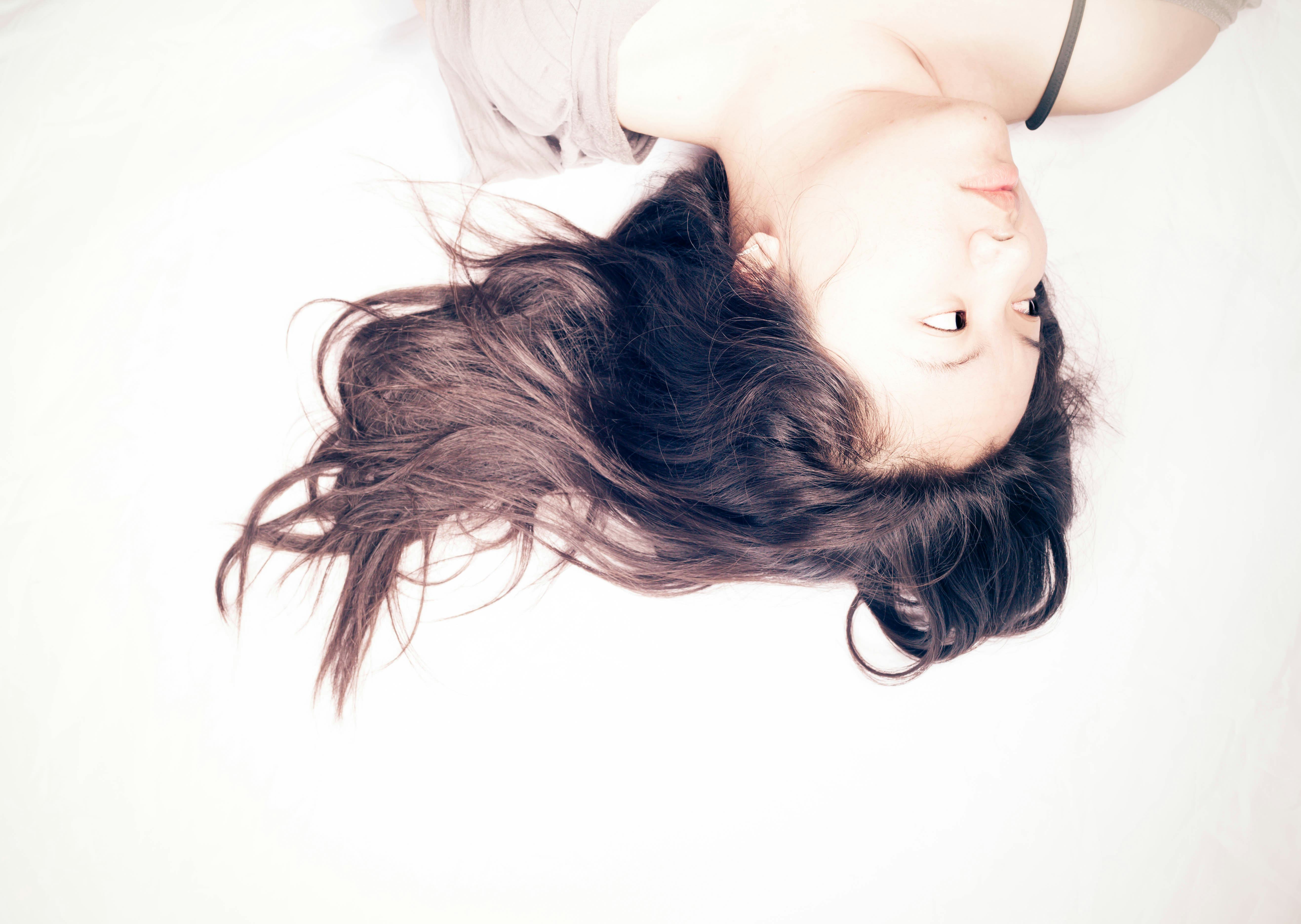 Woman lying in bed too tired to have sex 