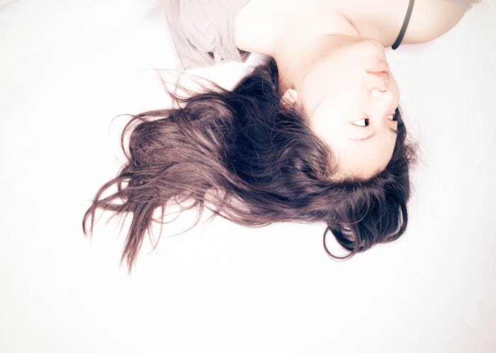 Woman lying in bed too tired to have sex