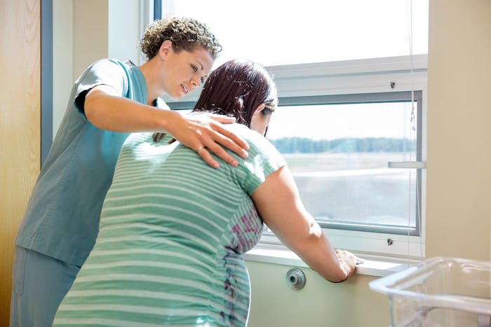 Doctor helping pregnant woman who is in labor