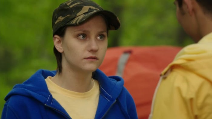 Adam Torres who was a transgender character on Degrassi in a blue hoodie, yellow tee and camo cap