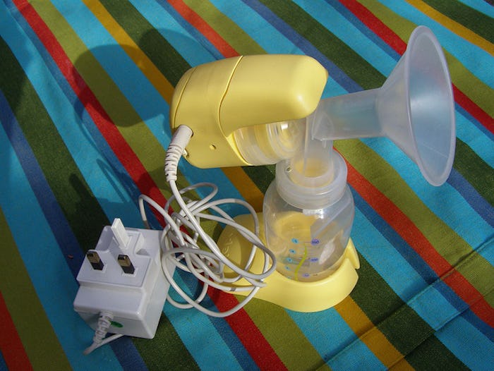 A breast pump on a colorful striped tablecloth