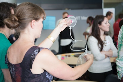 A woman holding a breast pump during the parenting class.