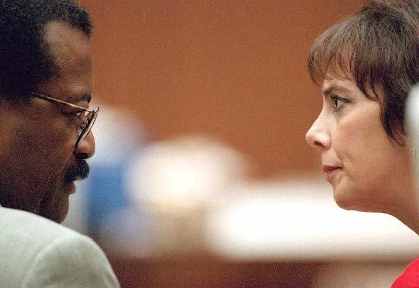 Johnnie Cochran and Marcia Clark are sitting in a courtroom facing each other.