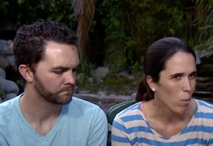 Foster parents sitting outside looking gravely to the side
