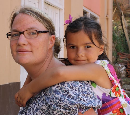 Eva Wieners carrying her daughter on her back after having survived the nepal earthquake