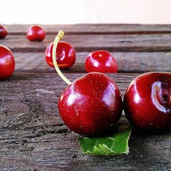 cherries sitting on a surface