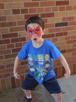 Son of Sarah Clouser posing with a red drawing on his face