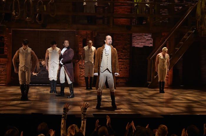 The cast of Hamilton performing the musical on stage