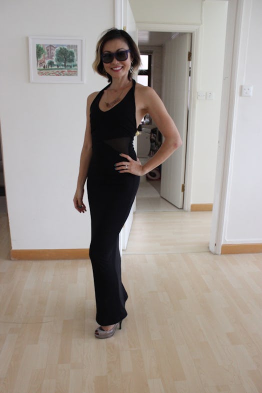 A woman dressed by her 3-year-old in a black maxi dress