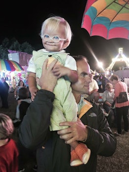 Amos being held by his father on a fair