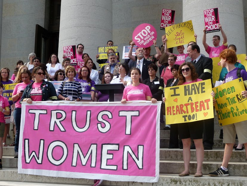 A group of women demonstrating and holding signs promoting their abortion rights
