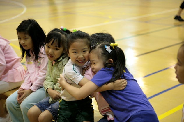 kids hugging in gymnasium