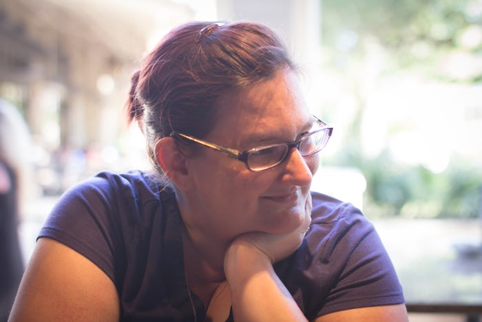 S. B. Castaneda, who tried hypnotherapy for her anxiety, smiling while sitting