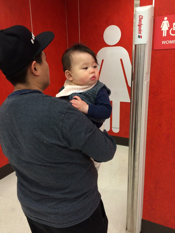 A parent taking their kid to the restroom