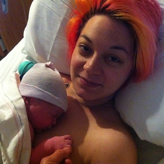 Mother with her newborn child on her chest
