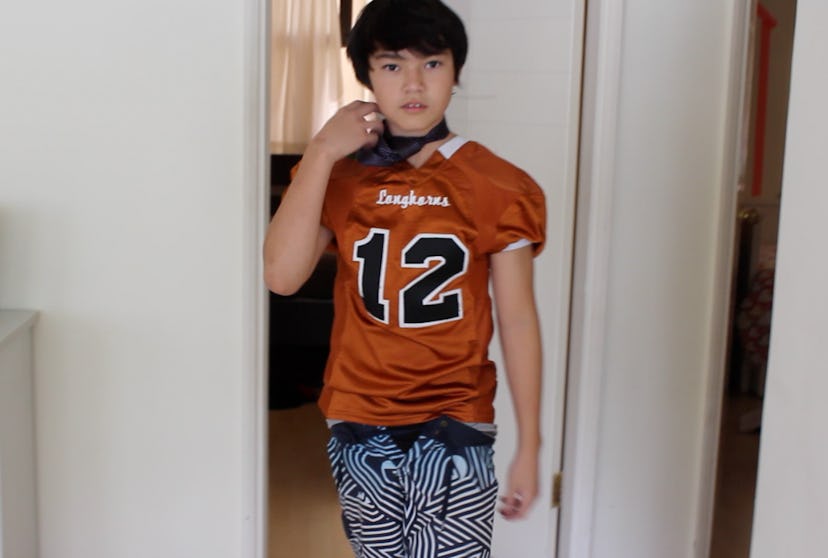 A boy wearing a sports chic look picked by his sister