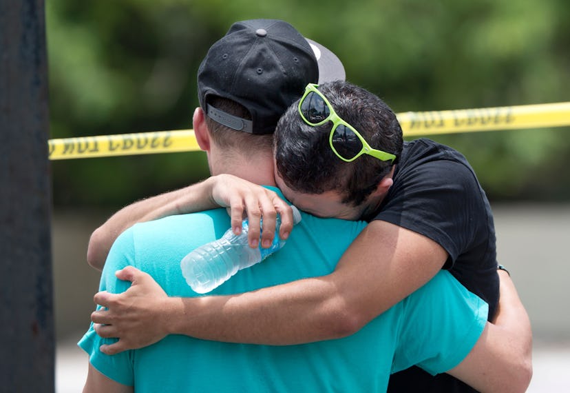 Two guys crying and hugging in a crime scene after the Orlando Club shooting