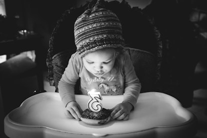 A three year old kid blowing her birthday candle
