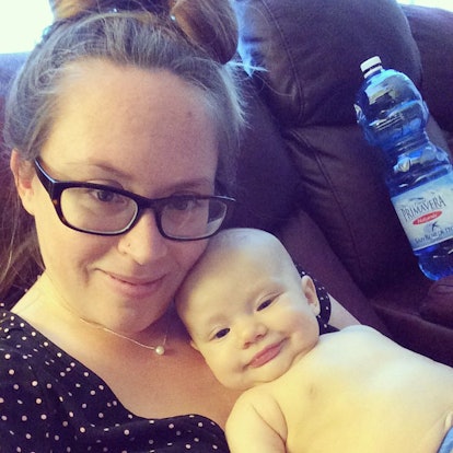 Stephanie Baroni-Cook poses with her baby lying on her chest