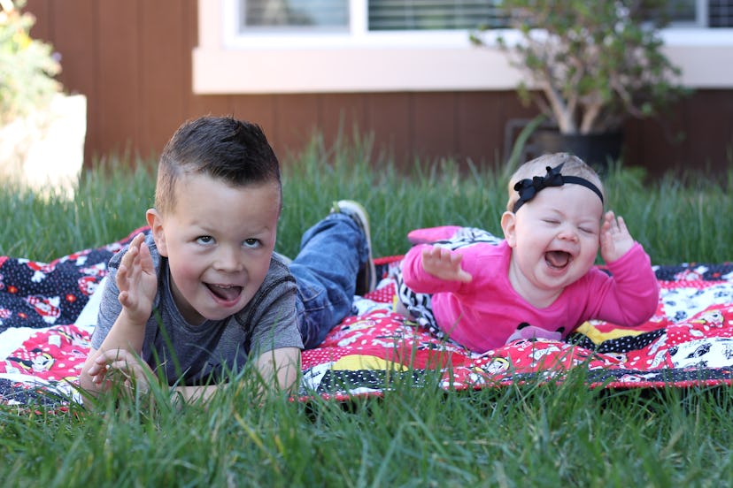 Baby siblings having a great time laughing and enjoying the picnic day