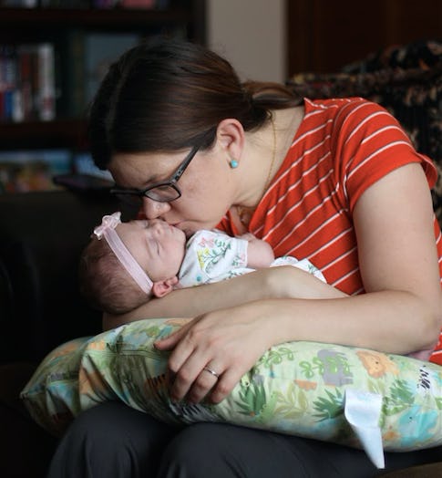 Samatha Taylor kissing her newborn baby