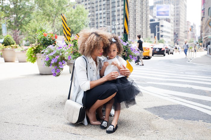 A mother from Massachusetts standing and talking on a street with her daughter