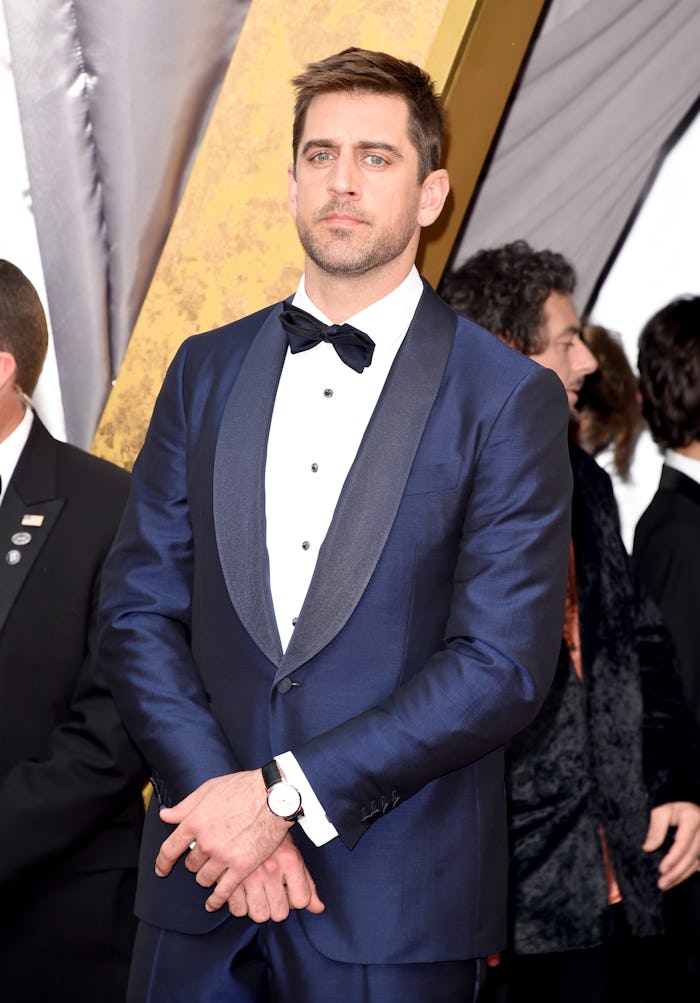 Aaron Rodgers in a suit and bow tie at a red carpet 