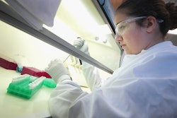A female forensic scientist holding a test tube in a laboratory