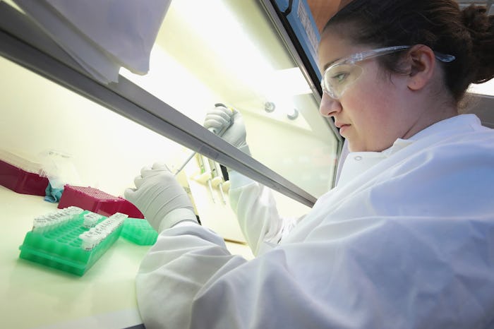 A female forensic scientist holding a test tube in a laboratory