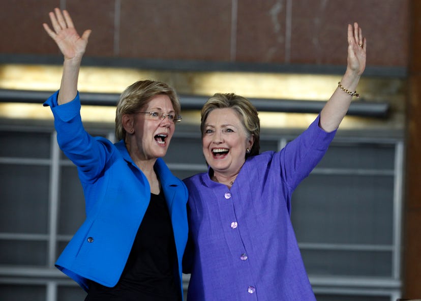 Hillary Clinton raising hands and greets the public together with her female friend