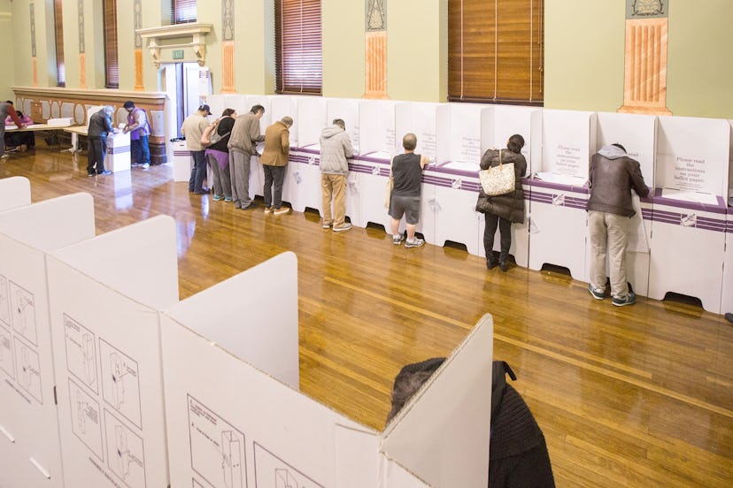 A photo of a few election voters in a hall