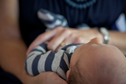 A mother struggling with postpartum depression holding her newborn baby