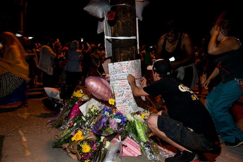 People leaving notes and flowers in memorial of the killed